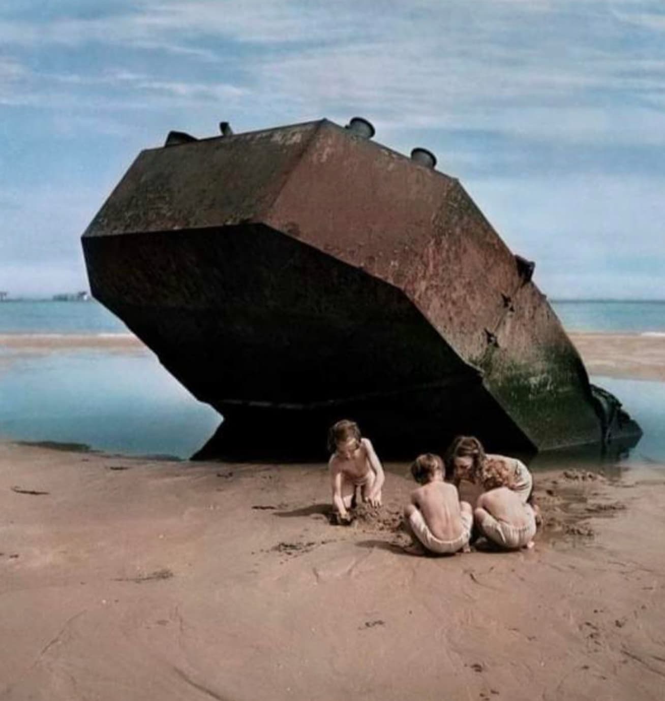 “Children playing among the wreckage of the D-Day invasion of Normandy, France, 1947.”